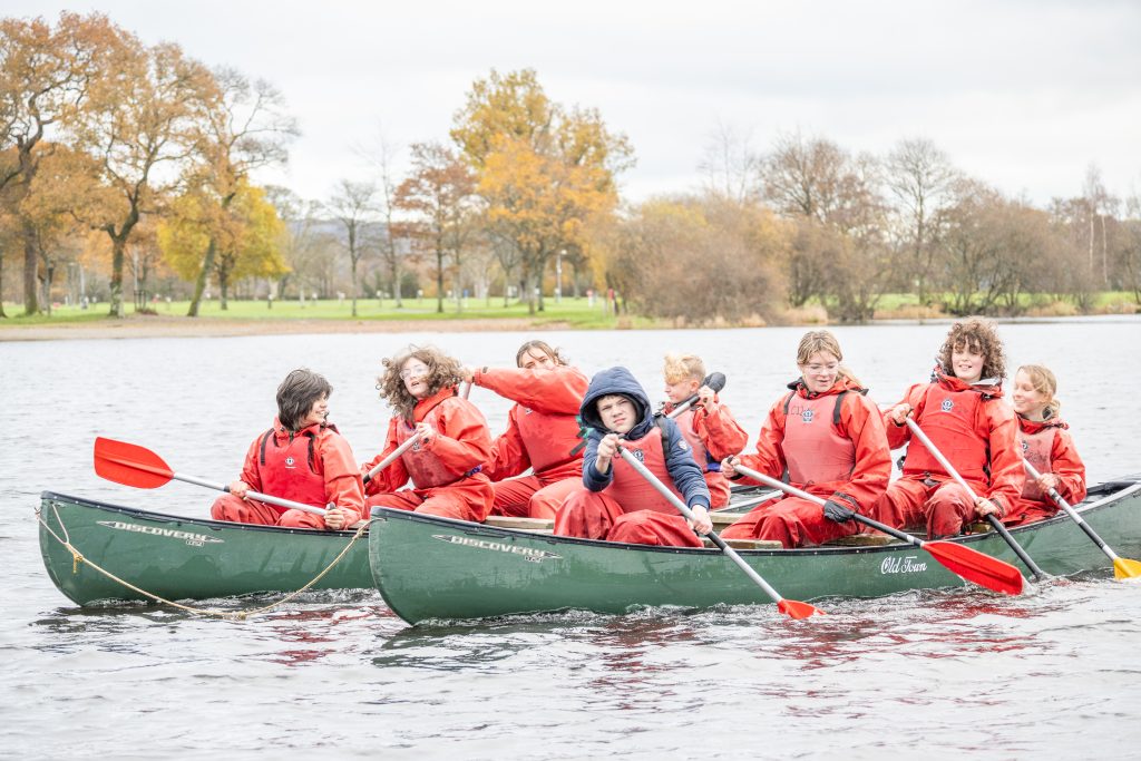 Children in canoes on a lake