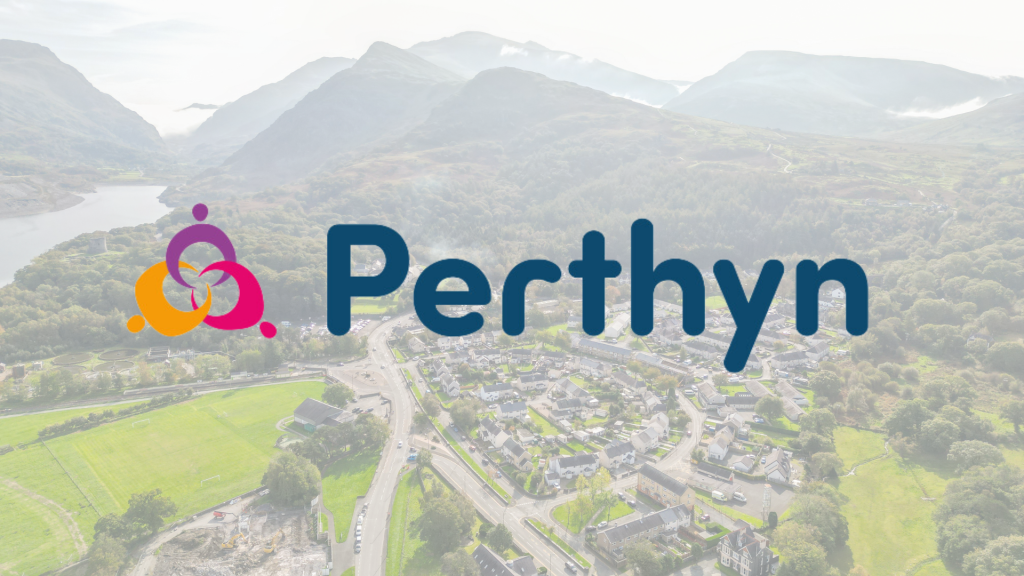 Photo of Llanberis from the sky with the mountains in the background, with the word 'Perthyn'