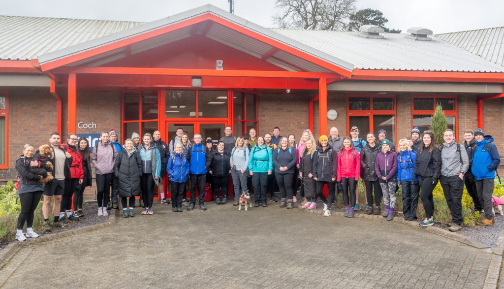 A group of Adra staff outside the Tŷ Coch office in Parc Menai.